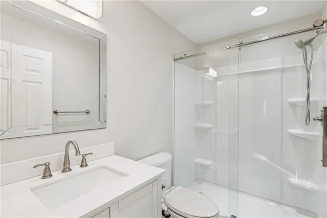 a bathroom with a sink toilet and shower