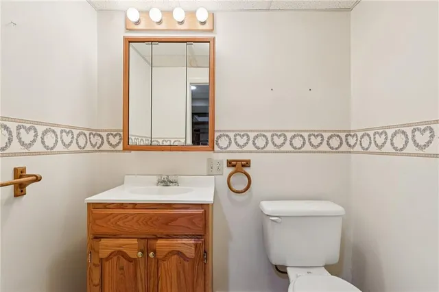 a bathroom with a toilet sink and mirror