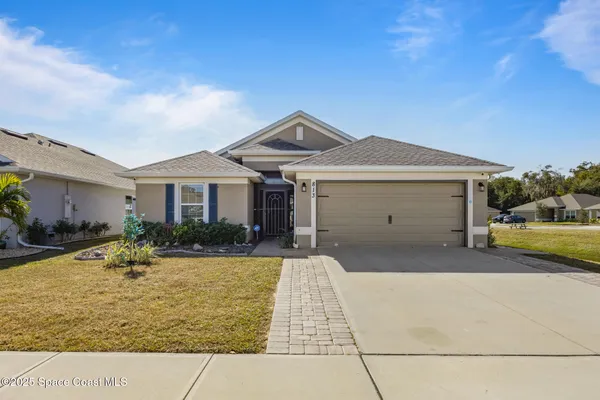 a front view of a house with a yard outdoor seating and garage