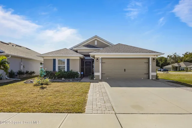 a front view of a house with a yard outdoor seating and garage
