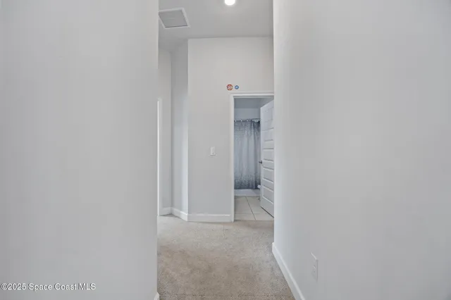 a view of a bathroom from a hallway