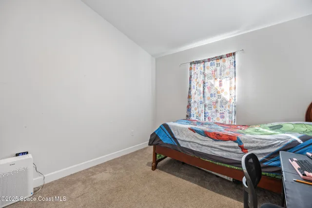 a room with a bed and a window