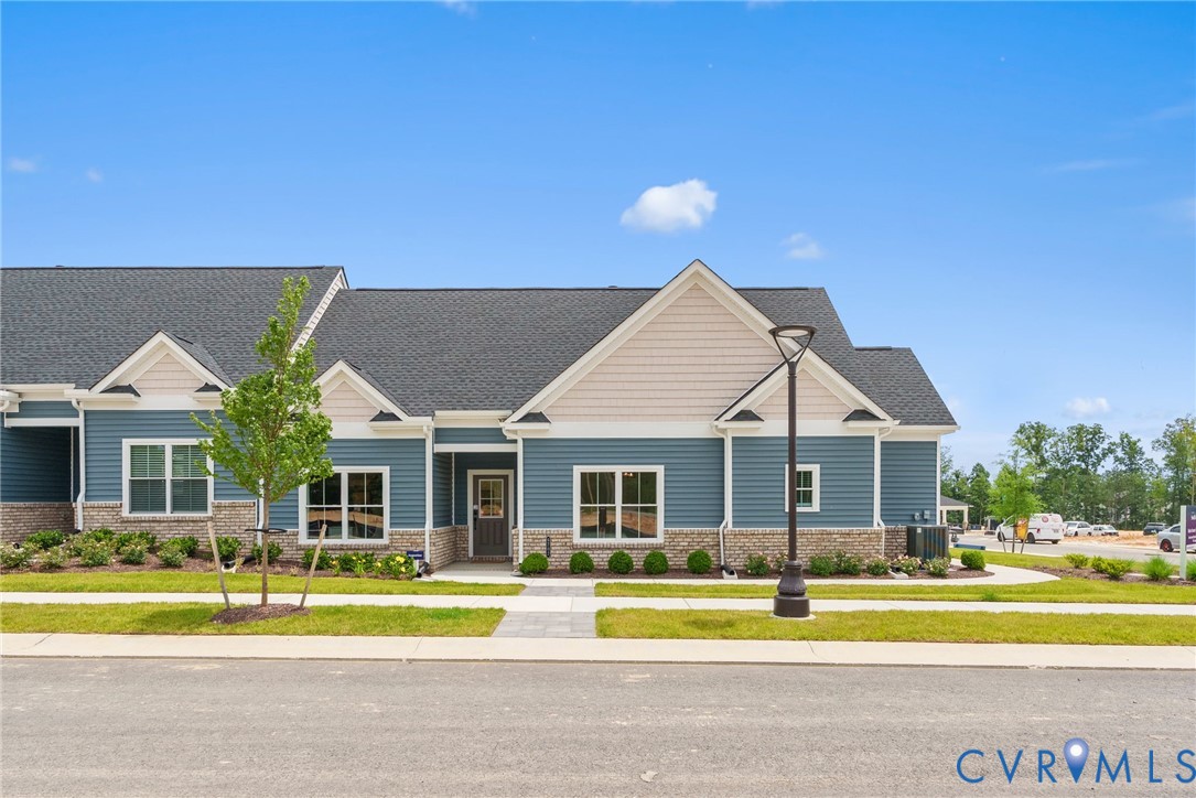 a front view of a house with a big yard and potted plants