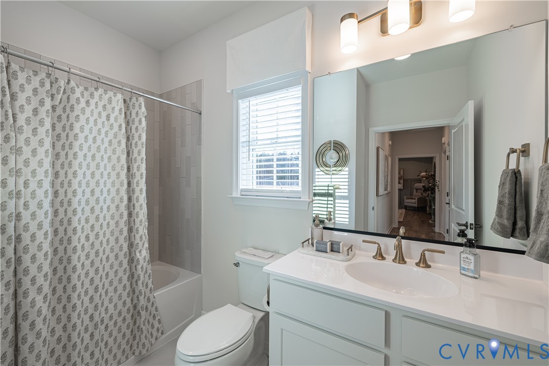 6609 Mayland Rdg Lane; Moseley, VA 23120 - Photo 15 of 20 a bathroom with a granite countertop sink toilet a mirror a vanity and shower