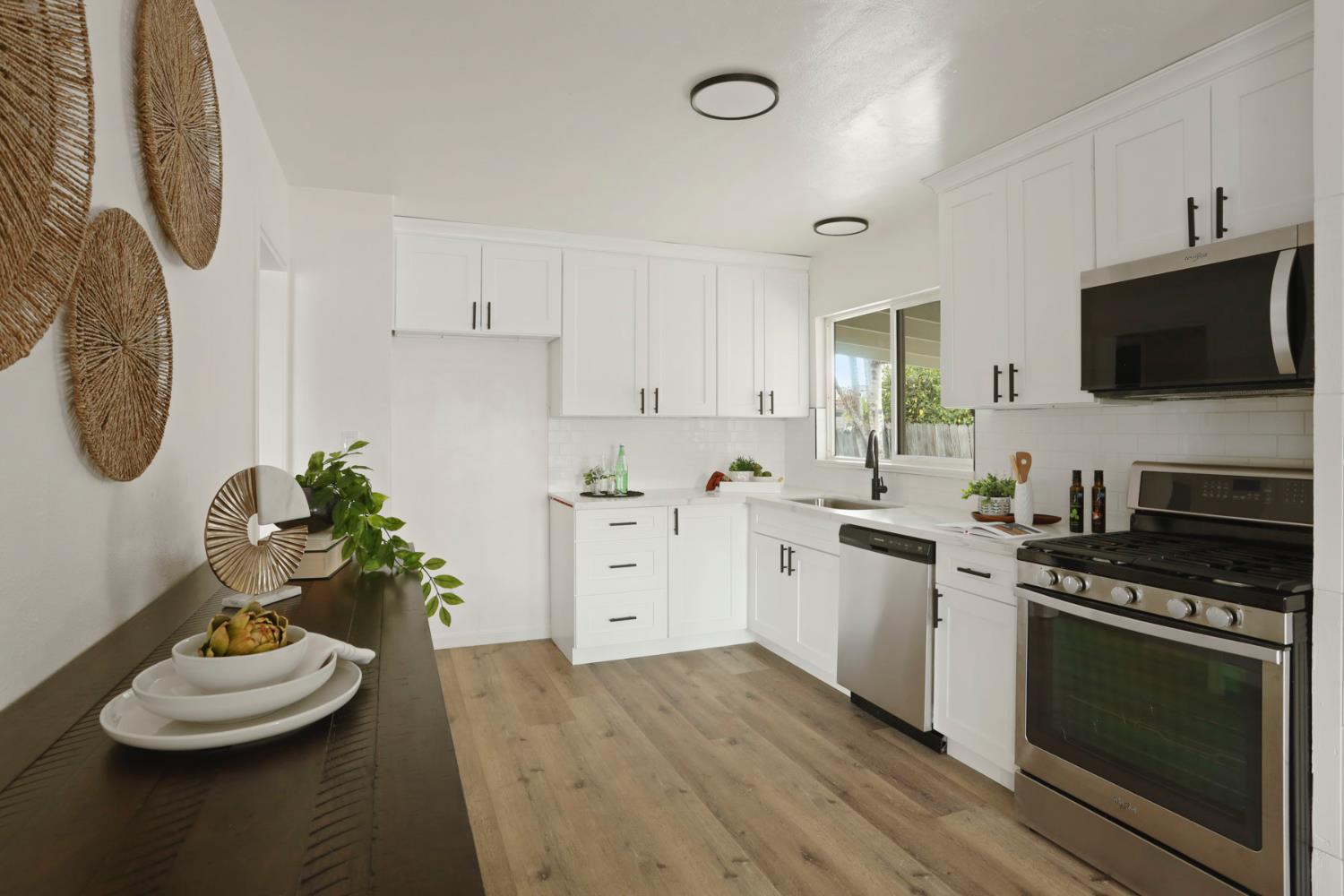1636 South School Street Lodi, CA 95240 - Photo 16 of 33 a kitchen with stainless steel appliances kitchen island granite countertop a stove a sink and a white stove