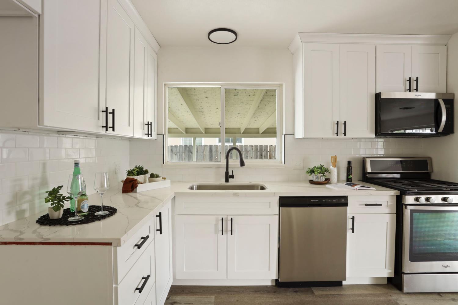 1636 South School Street Lodi, CA 95240 - Photo 17 of 33 a kitchen with sink a microwave and cabinets