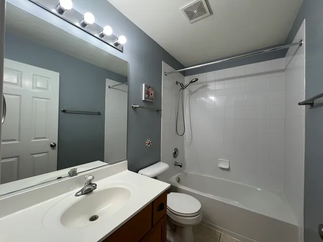 a bathroom with a sink mirror toilet and bathtub