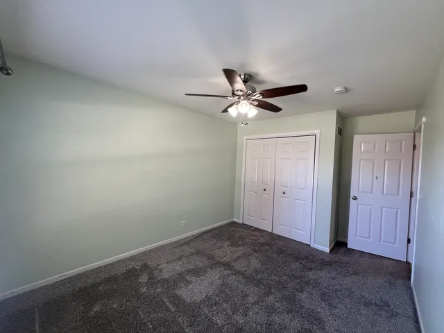 a view of a livingroom with a chandelier fan