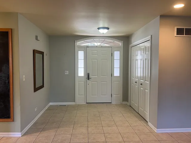 wooden floor with a chandelier in a room