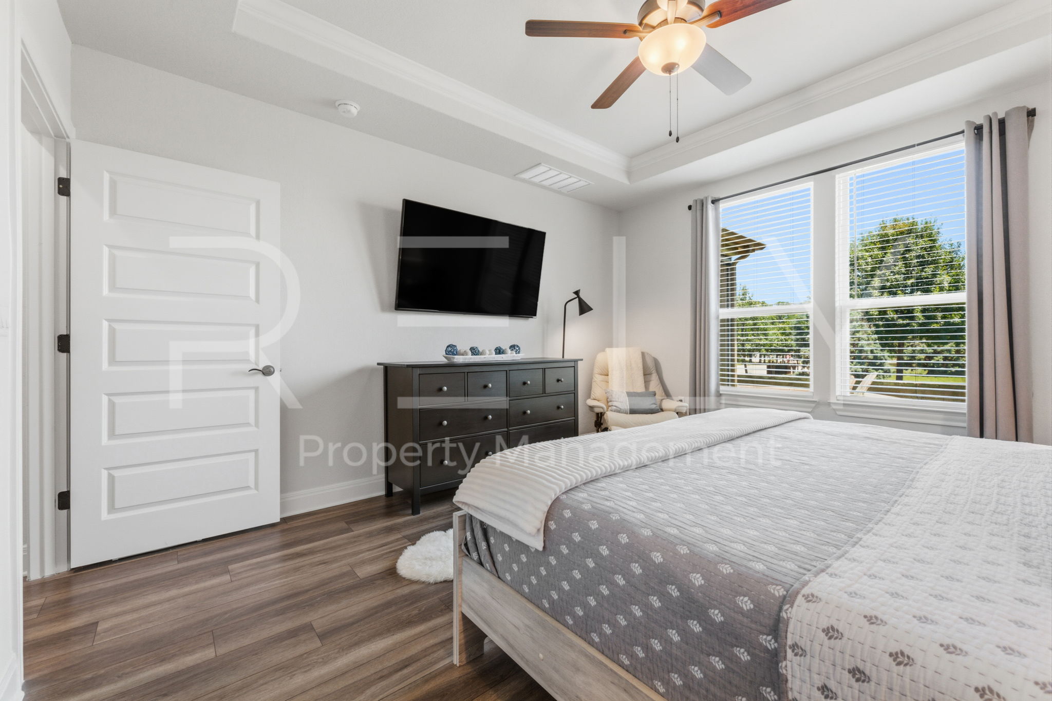 101 Spanish Star Street Georgetown, TX 78633 - Photo 22 of 39 A tranquil bedroom with rich wood flooring and a refreshing ceiling fan invites serene repose.