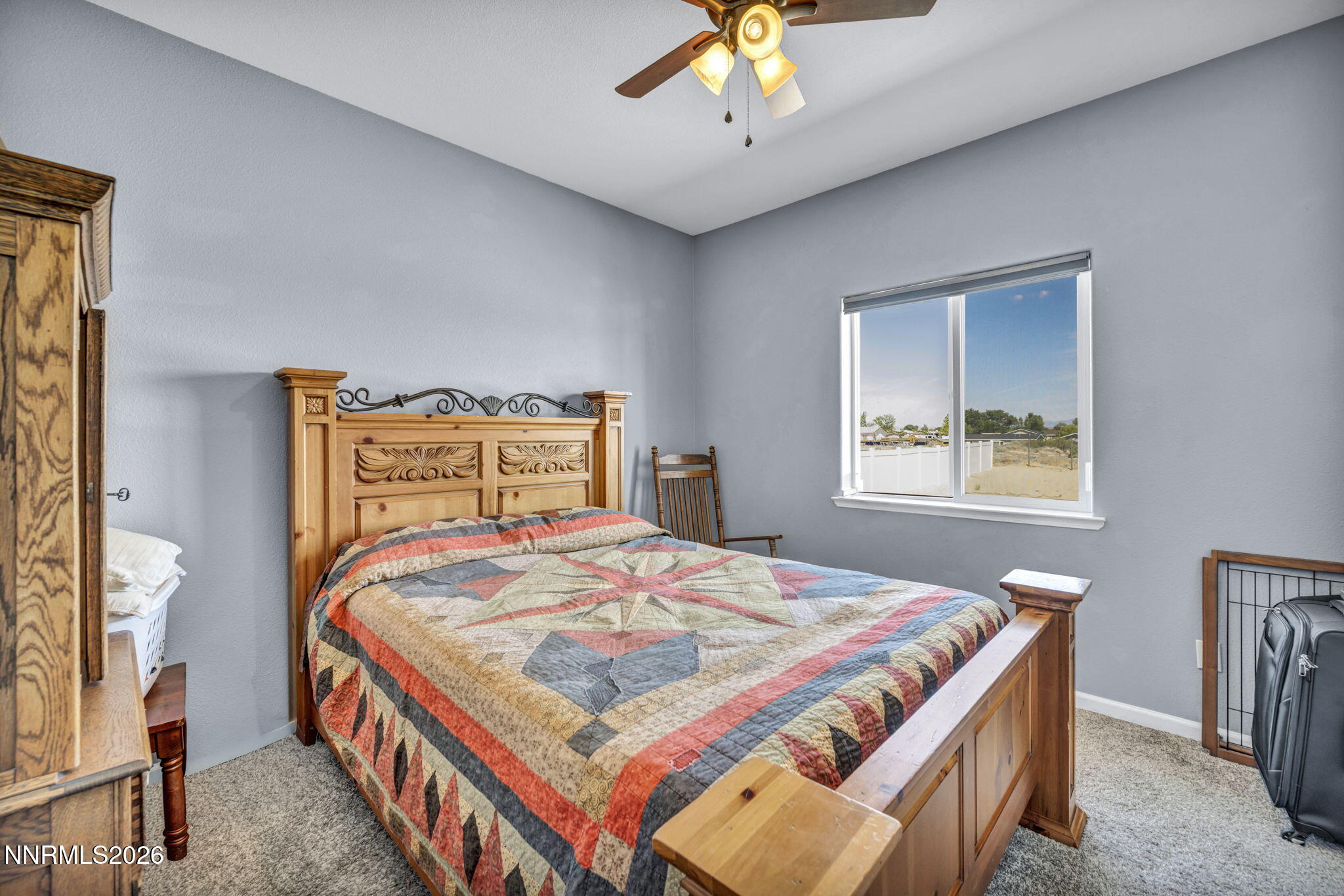 1286 Sky Ridge Drive Fallon, NV 89406 - Photo 34 of 49 a bedroom with a bed and a chandelier