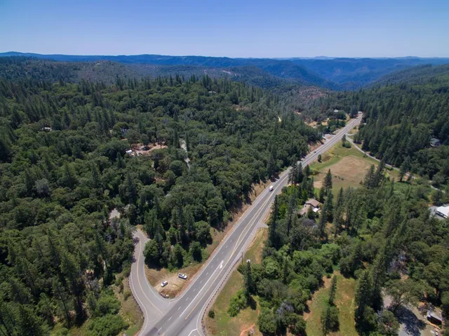 a view of a house with a yard and flowers