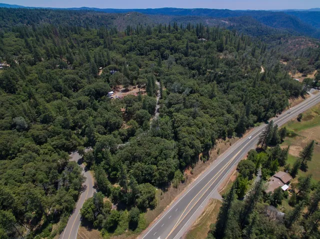 an aerial view of a house with a yard