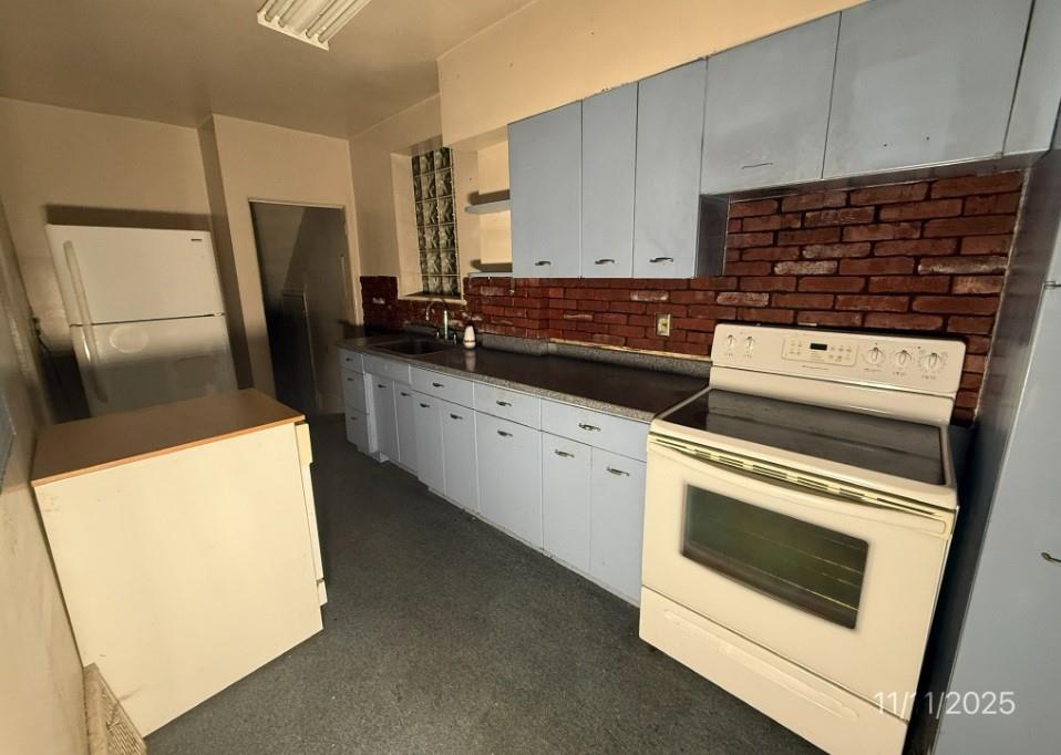 2831 Custer Avenue Pittsburgh, PA 15227 - Photo 9 of 28 a kitchen with granite countertop a refrigerator stove and sink