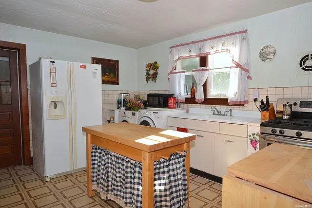 a kitchen with stainless steel appliances a stove a sink and a refrigerator