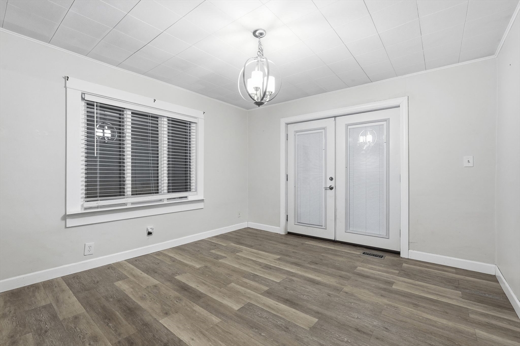 18 Charpentier Boulevard Chicopee, MA 01013 - Photo 11 of 37 a view of an empty room with wooden floor and windows