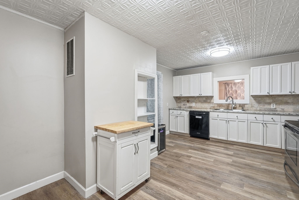 18 Charpentier Boulevard Chicopee, MA 01013 - Photo 13 of 37 a kitchen with a stove top oven sink and cabinets
