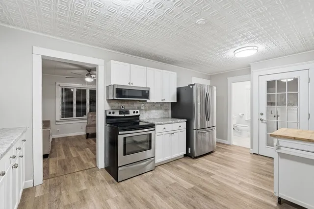 a kitchen with stainless steel appliances granite countertop a refrigerator stove and sink