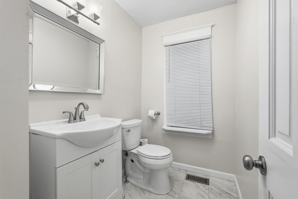 18 Charpentier Boulevard Chicopee, MA 01013 - Photo 16 of 37 a bathroom with a toilet a sink a mirror and vanity