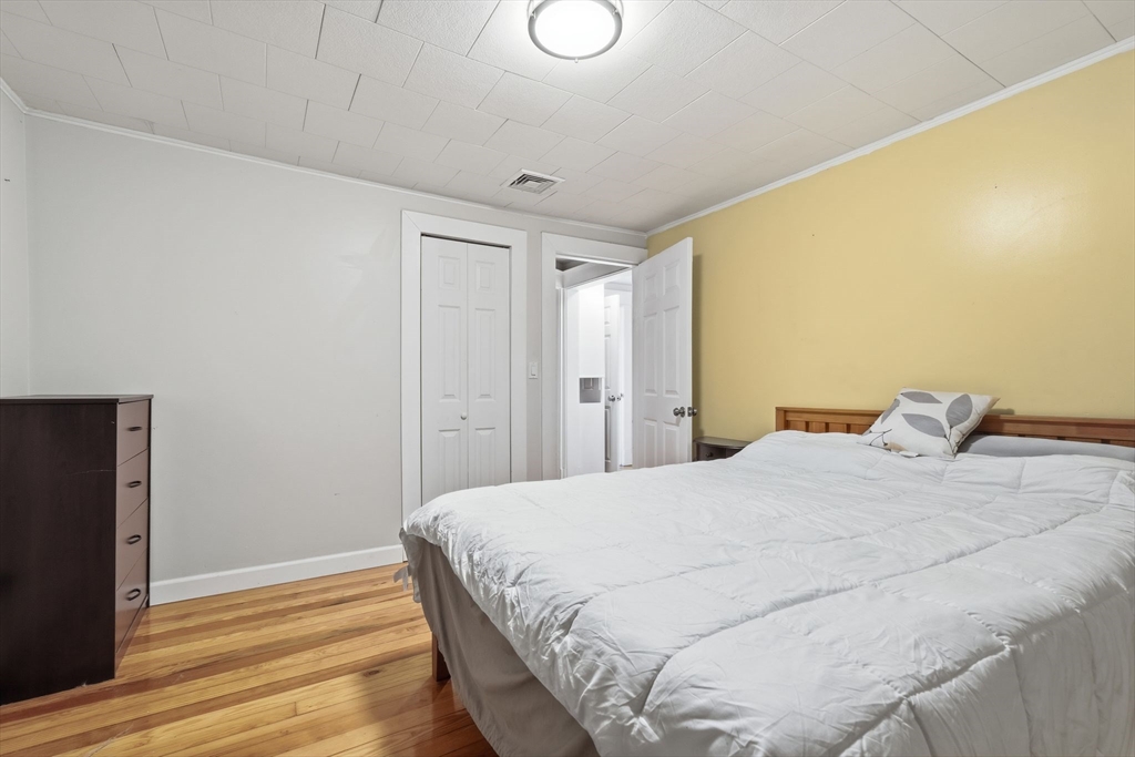 18 Charpentier Boulevard Chicopee, MA 01013 - Photo 18 of 37 a bedroom with a bed and wooden floor