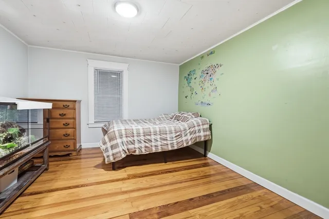 a bedroom with a bed and a dresser