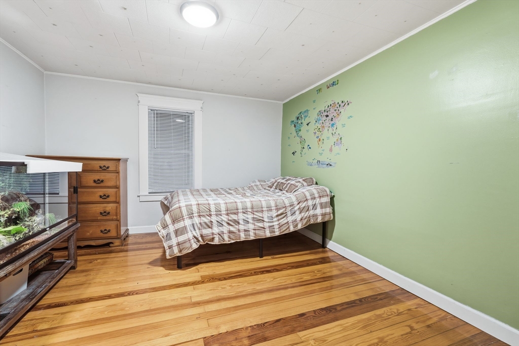 18 Charpentier Boulevard Chicopee, MA 01013 - Photo 19 of 37 a bedroom with a bed and a dresser