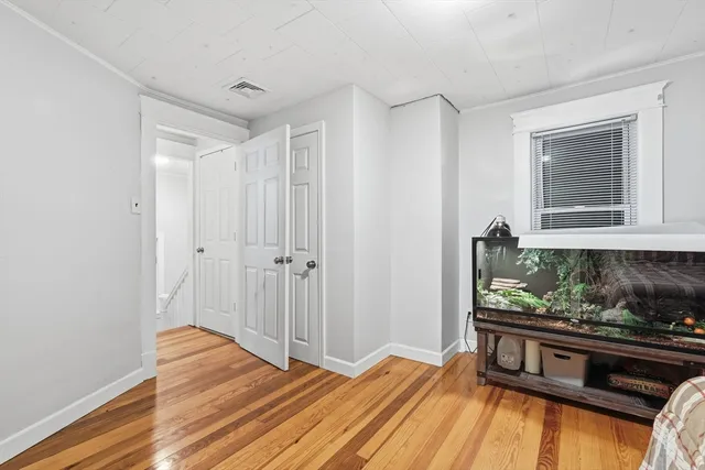 a view of an empty room and wooden floor