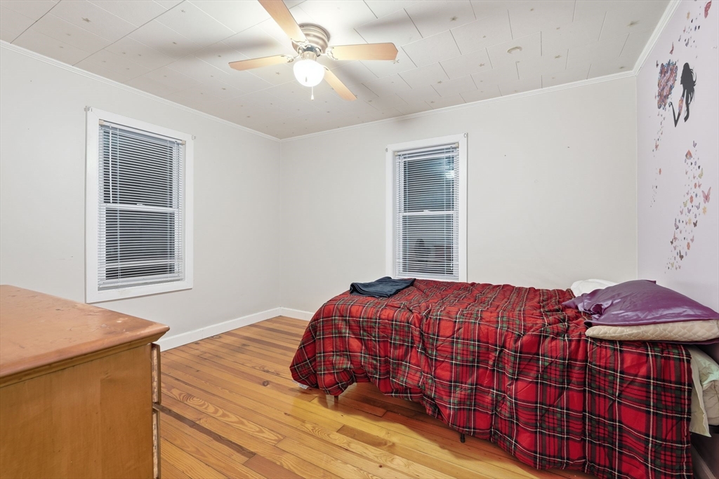 18 Charpentier Boulevard Chicopee, MA 01013 - Photo 21 of 37 a bedroom with a bed and wooden floor