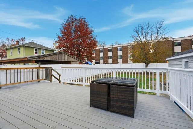 a view of a roof deck with wooden floor and fence