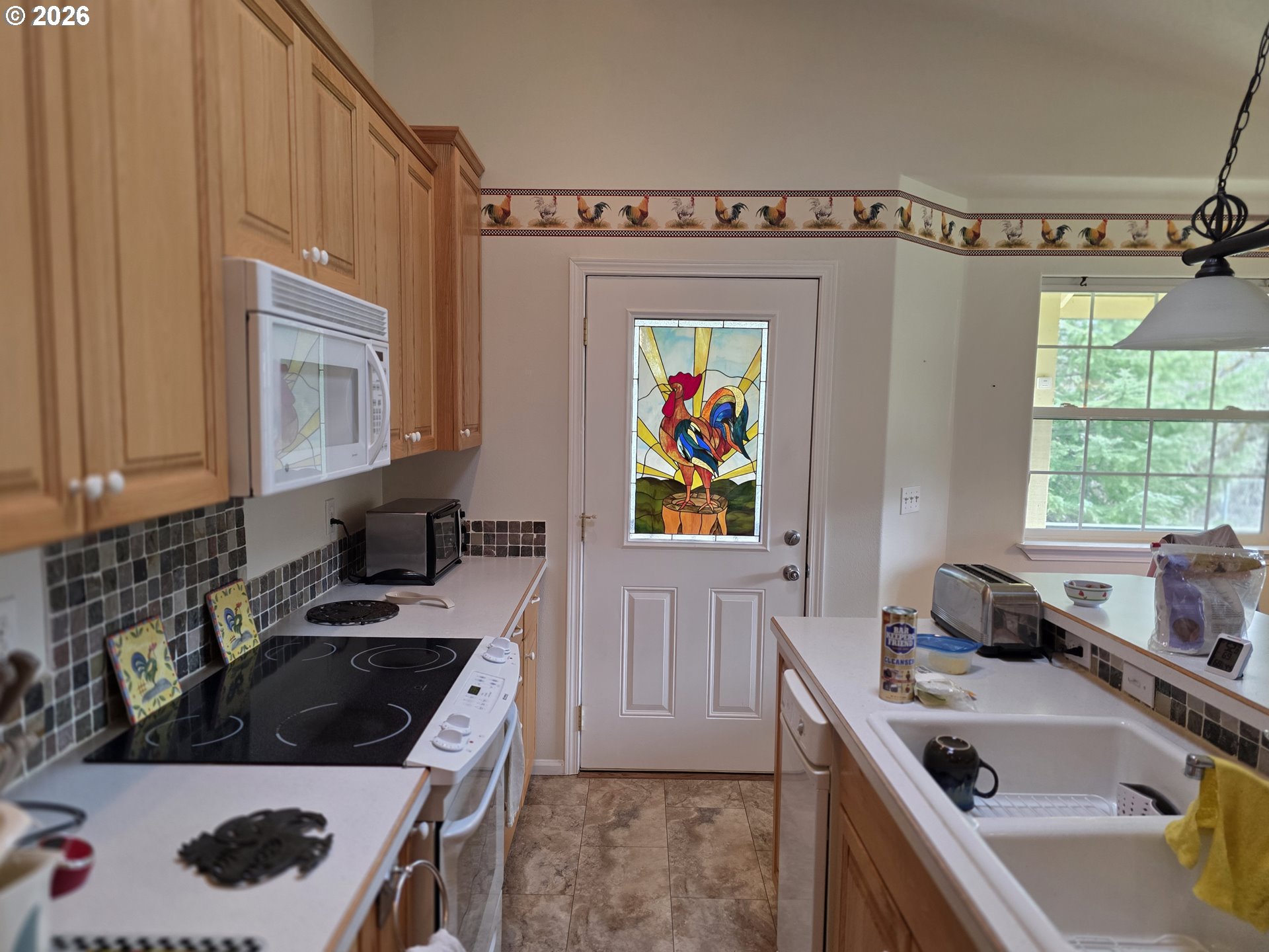 1909 Southwest Duke Road Sutherlin, OR 97479 - Photo 11 of 30 a kitchen that has a sink and a stove in it