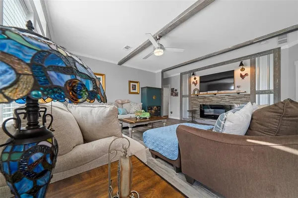 a living room with furniture a fireplace and a flat screen tv