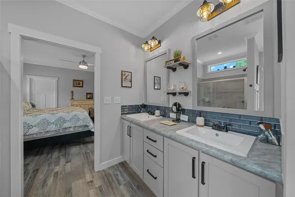 a en suite bathroom with a double vanity sink and a mirror