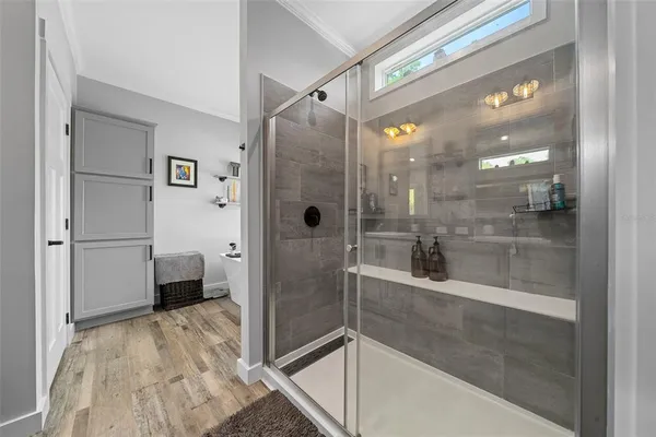 a bathroom with a glass shower door and a glass door shower