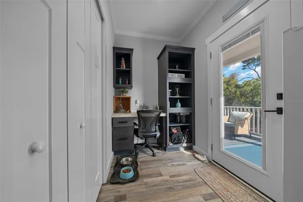 a view of a livingroom with workspace and a window