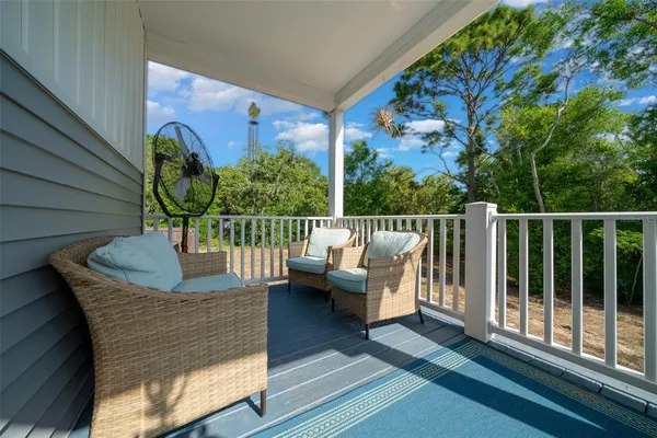 a balcony with furniture and wooden floor
