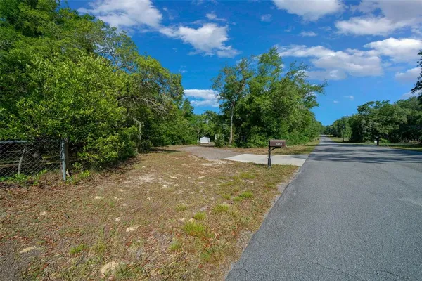 a view of a road with a yard
