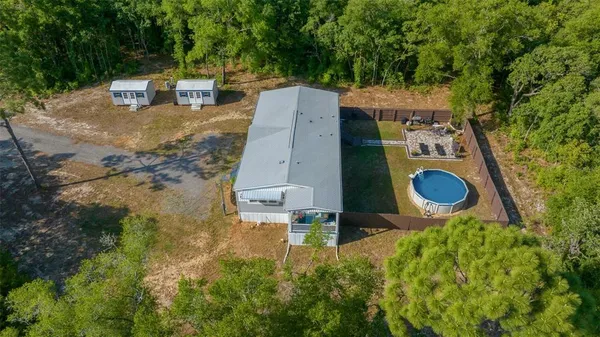 an aerial view of a house with yard swimming pool and outdoor seating