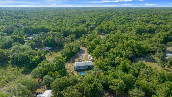an aerial view of a house with a yard