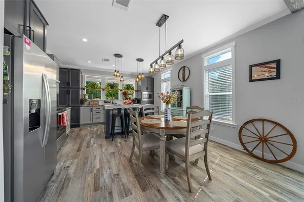 a view of a dining room with furniture and a chandelier