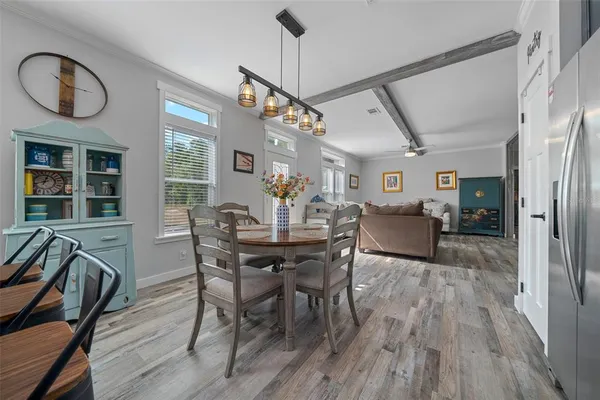 a view of a dining room with furniture window and wooden floor