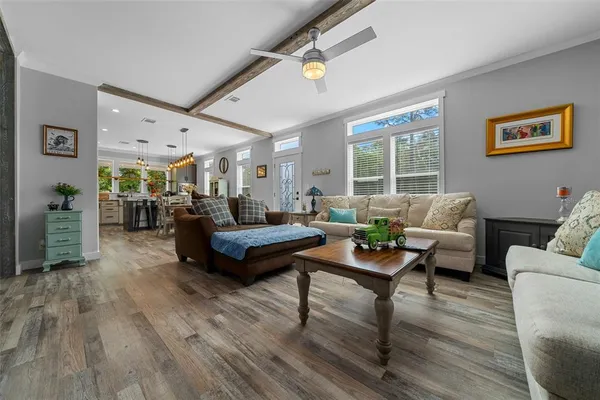 a living room with furniture and wooden floor