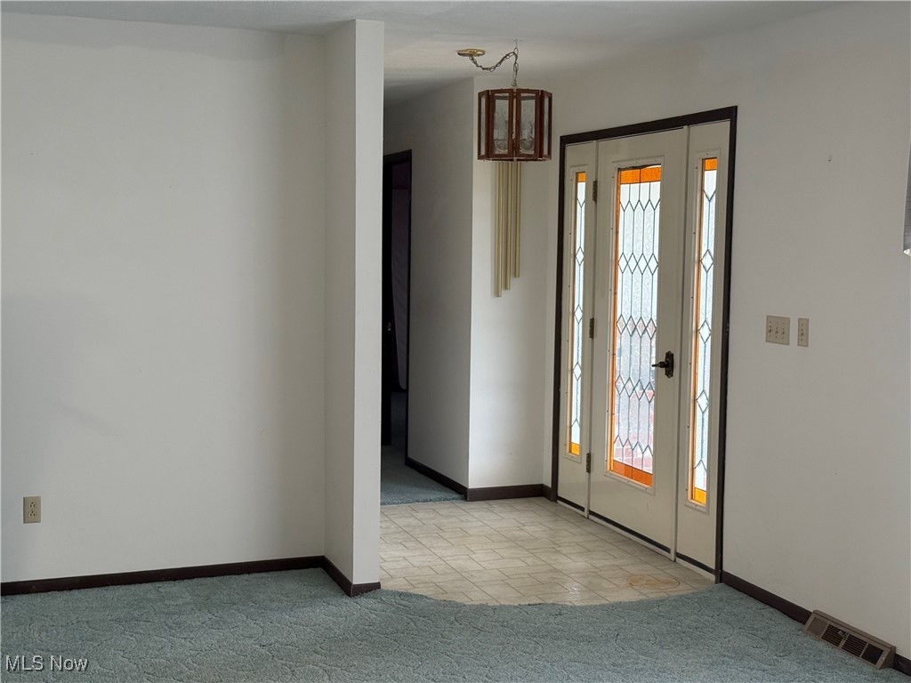 68697 Morristown Flushing Road Flushing, OH 43977 - Photo 11 of 33 Foyer featuring plenty of natural light, carpet flooring, visible vents, and baseboards