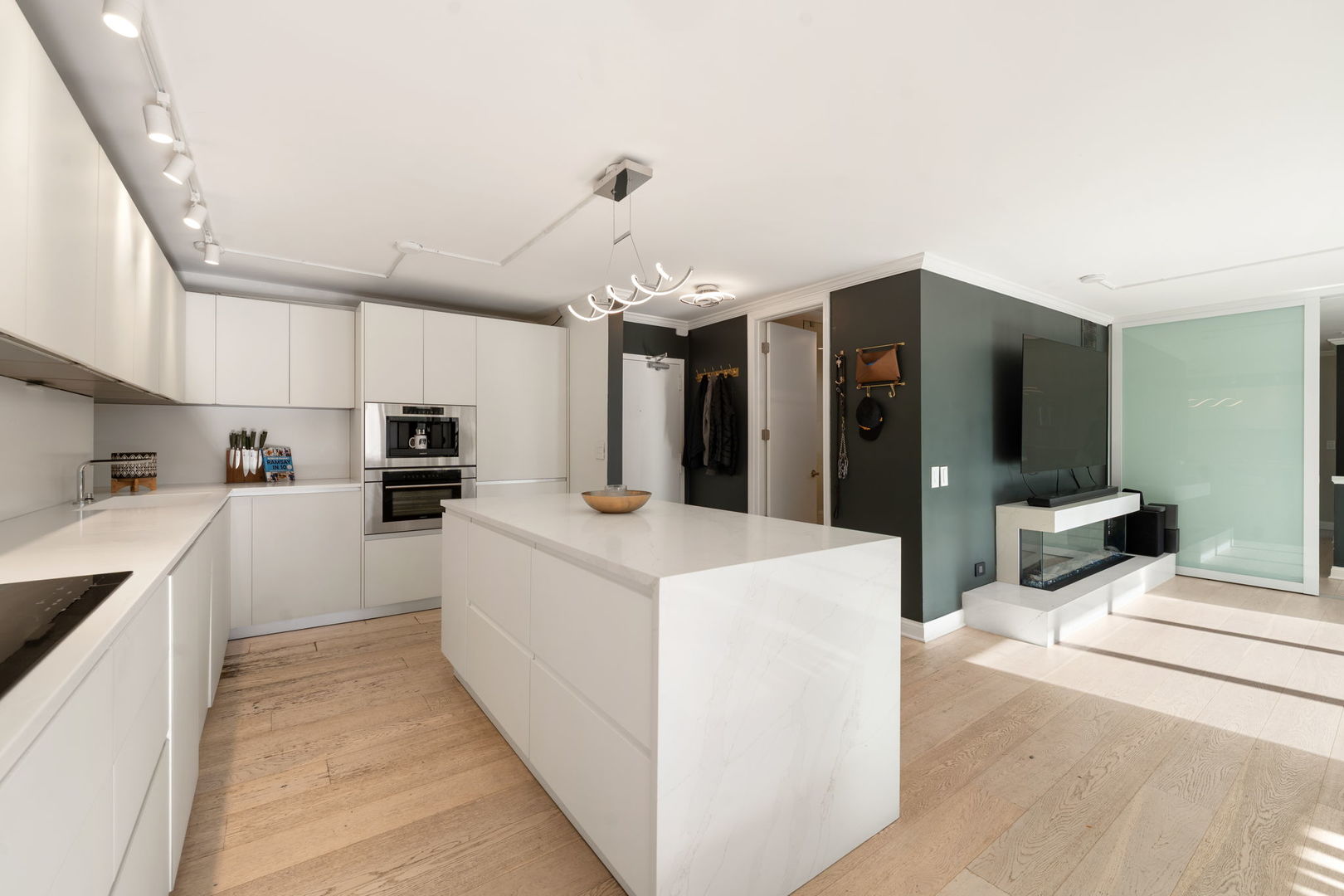 1516 North State Parkway, Unit 5D Chicago, IL 60610 - Photo 3 of 33 a large white kitchen with cabinets a sink and a stove