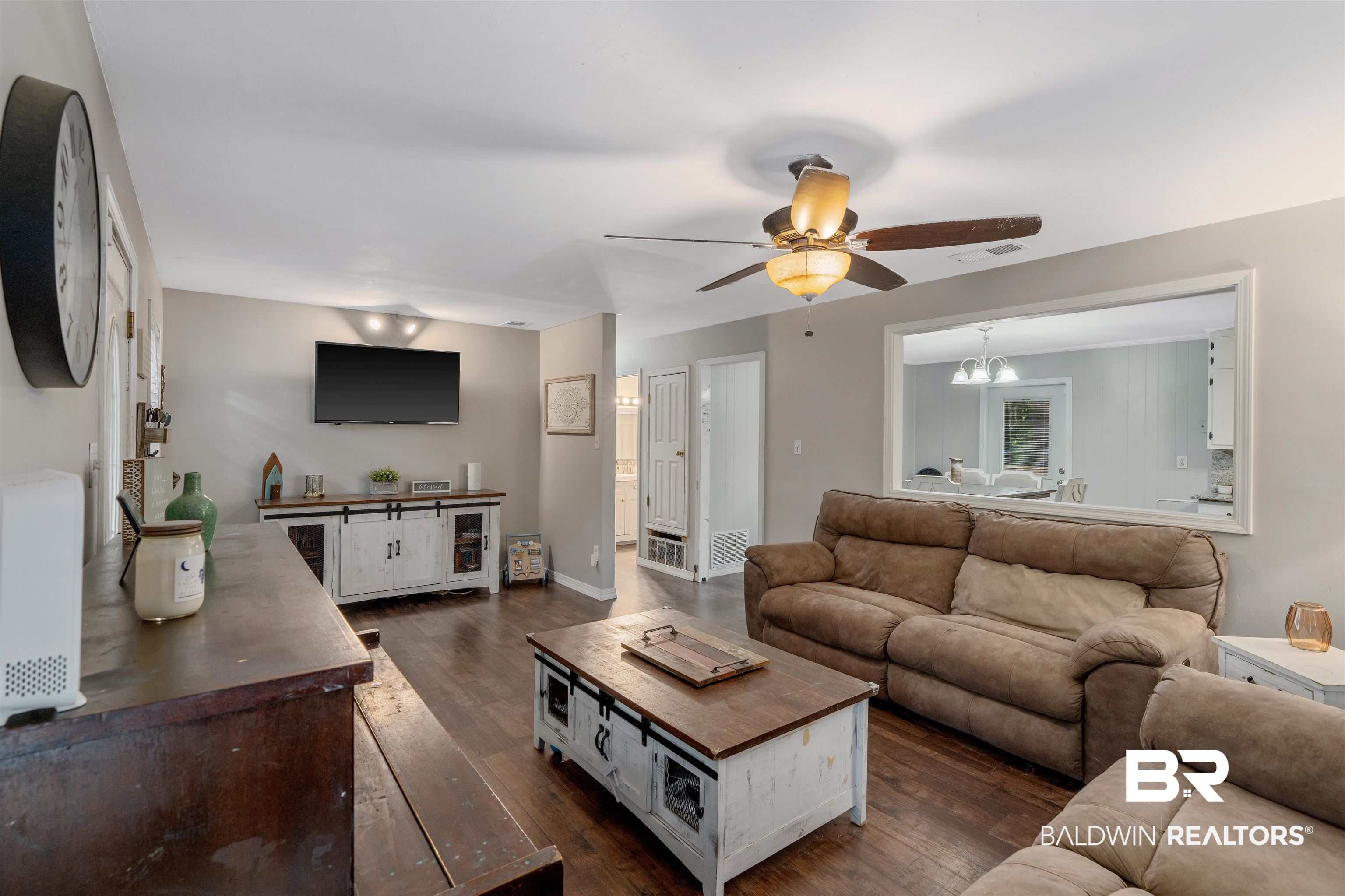 922 Dauphine Circle Daphne, AL 36526 - Photo 5 of 29 Living area featuring ceiling fan, dark wood-type flooring, and a chandelier