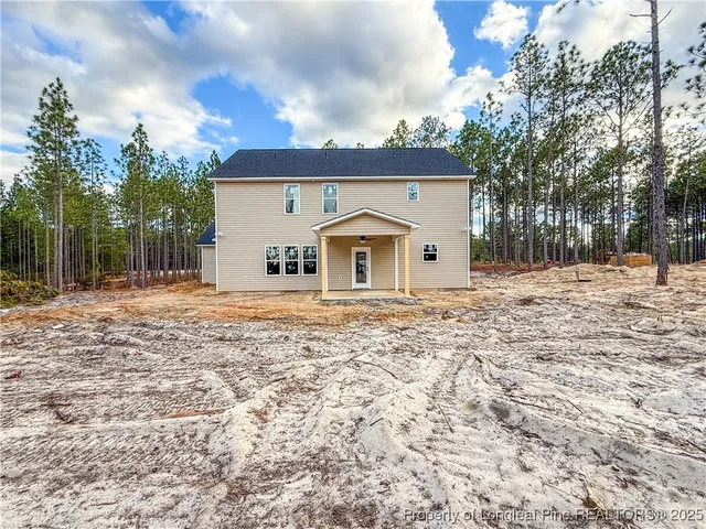 a view of a lake with green field and mountains