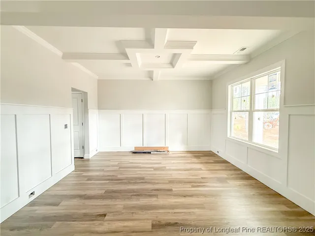 an empty room with a fireplace and windows