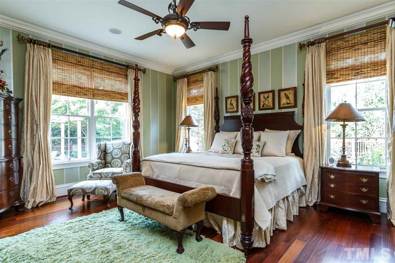 3721 Rolston Drive Raleigh, NC 27609 - Photo 14 of 30 a bedroom with a bed and a large window with wooden floor