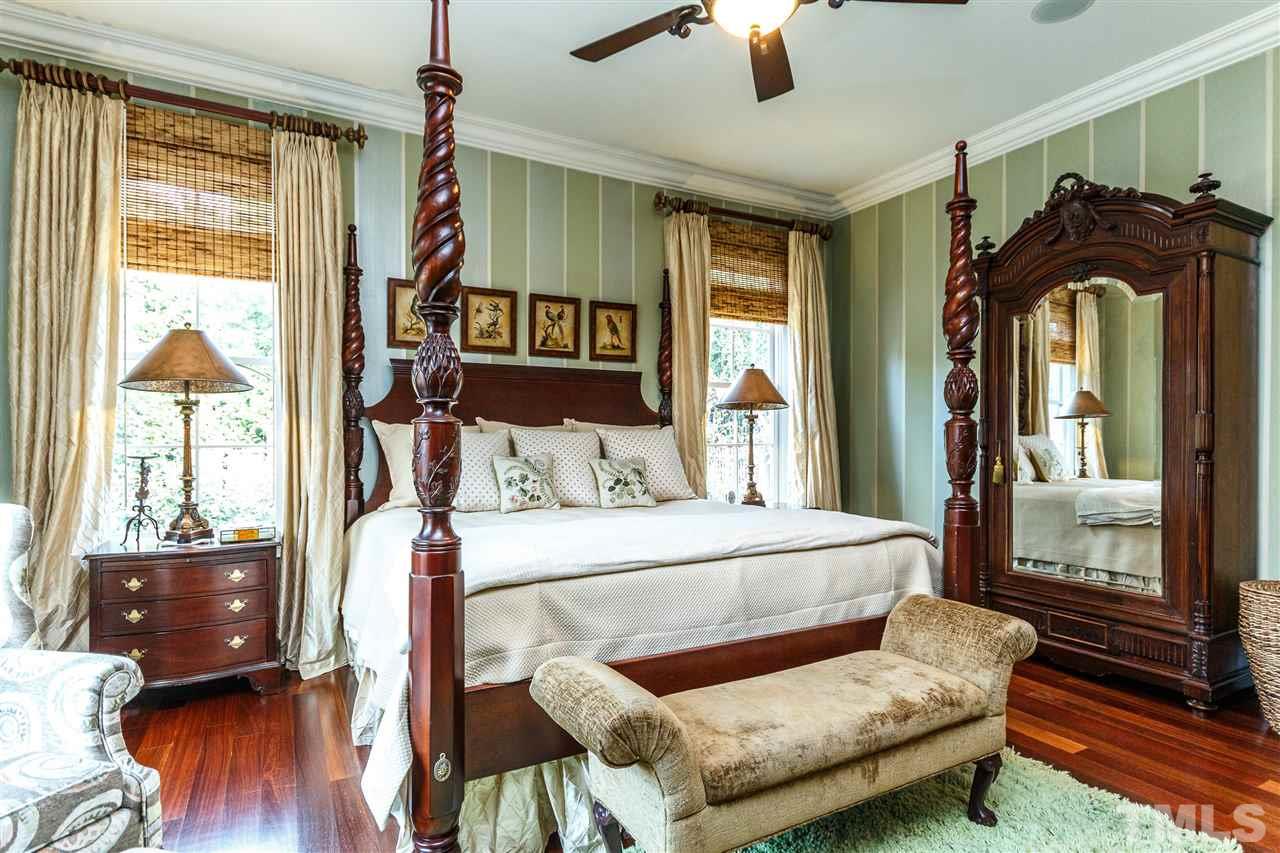 3721 Rolston Drive Raleigh, NC 27609 - Photo 15 of 30 a bedroom with a bed and wooden floor
