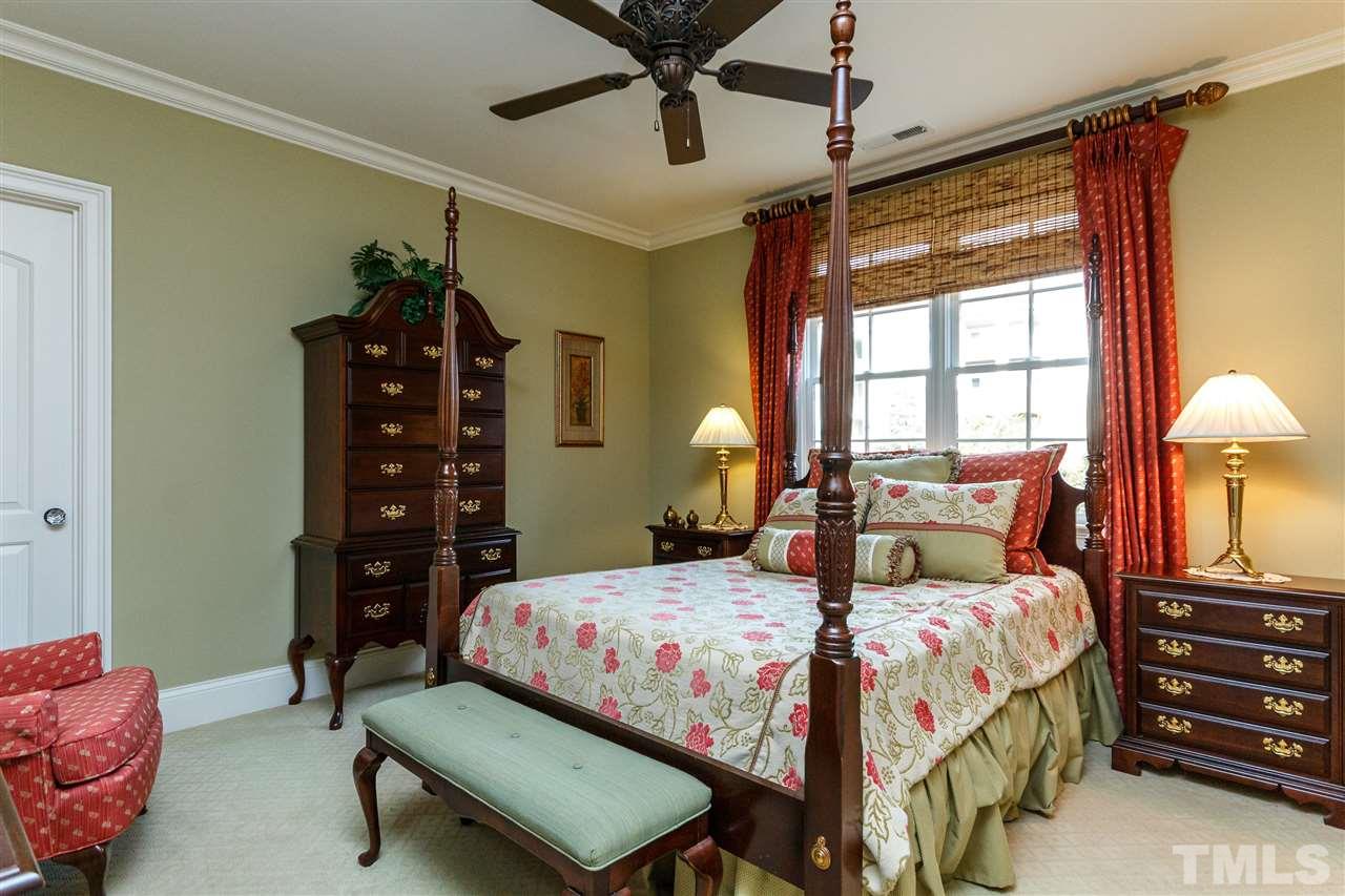 3721 Rolston Drive Raleigh, NC 27609 - Photo 21 of 30 a bedroom with a bed and a chandelier