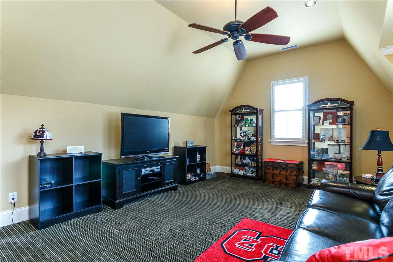 3721 Rolston Drive Raleigh, NC 27609 - Photo 23 of 30 a living room with furniture and a flat screen tv